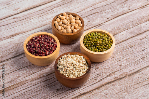 Mung beans, Red kidney beans, Chickpeas source and peeled barley in a basket wooden isolated on wood background