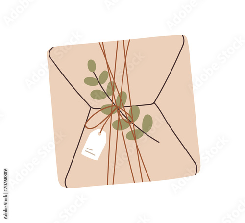 Kraft gift box with leaf plant, branch decoration. Holiday present in eco pap...