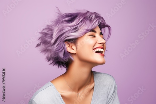 Portrait of a beautiful woman with purple hair on a purple background
