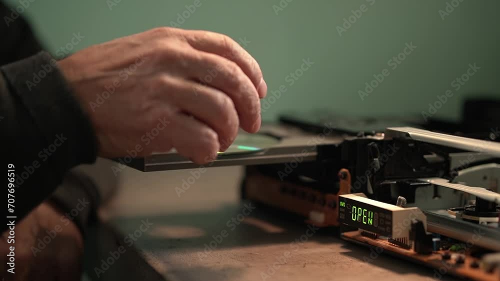 an elderly man and a CD player. consumer electronics repair.close-up of CD.High quality video in 4k an elderly man and a CD player. consumer electronics repair.close-up of CD.High quality video in 4k