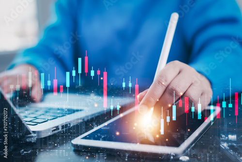 Businessman interacting with laptops, phones, and tablets with featuring stock tickers or graphs, cryptocurrency and new trading platforms, ideas and perspectives, Stock investment,New technology photo