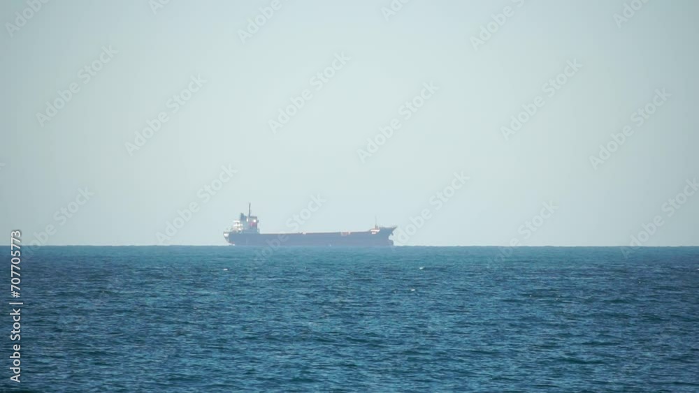 Cargo industrial ships sailing in to sea horizon. One large cargo ship grain carrier tanker in sea on sunny day. Transport, sea freight, sea transportation of cargo. Aerial view Cargo industrial ships sailing in to sea horizon. One large cargo ship grain carrier tanker in sea on sunny day. Transport, sea freight, sea transportation of cargo. Aerial view
