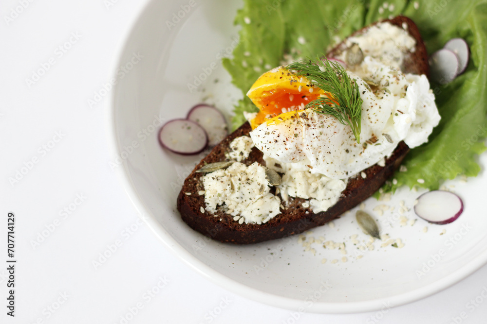 Poached Free Range Egg on Rye Bread Toast with Cream Cheese, Black Pepper, Seeds. Breakfast, Brunch Food Concept. 