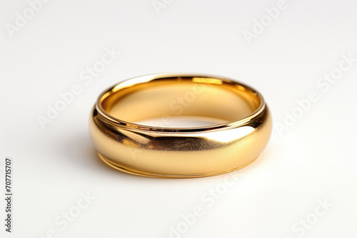 Gold wedding ring on a light background
