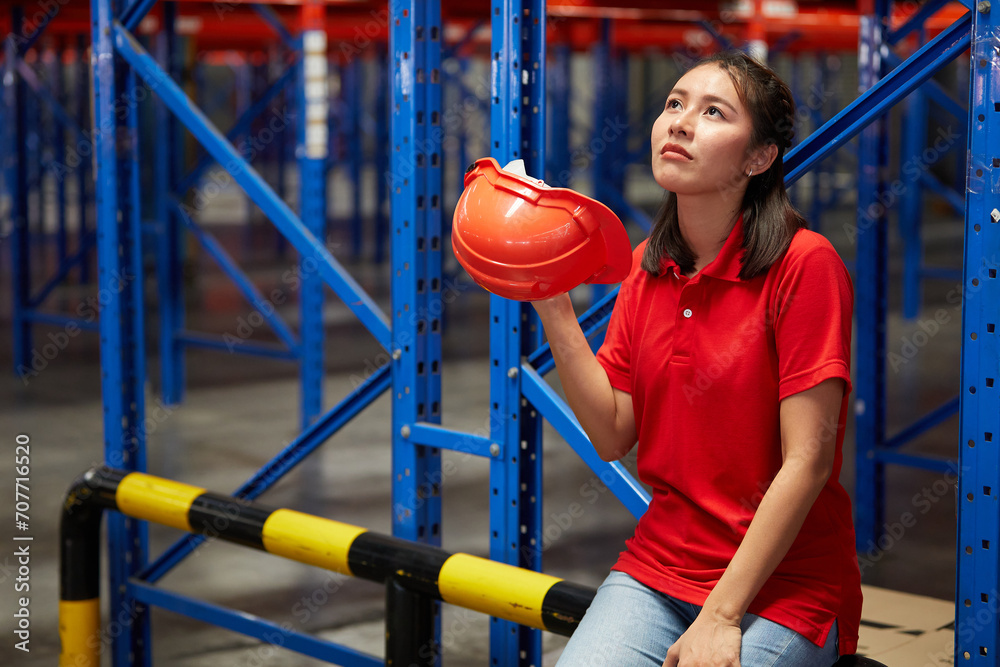 worker taking a break from hard work in the warehouse storage