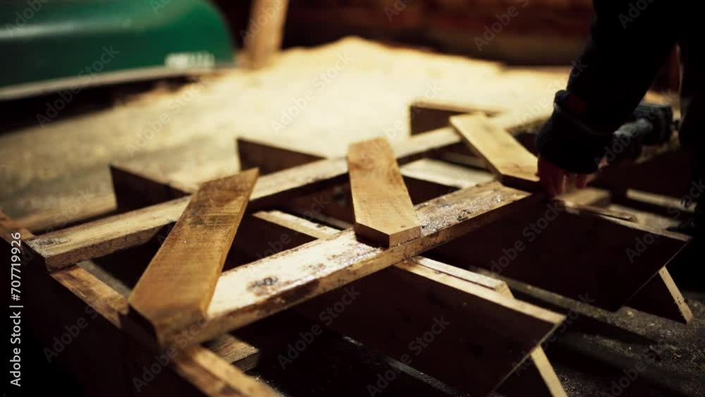 A Man is Driving Nails Into the Sawbuck Using a Drill in Indre Fosen, Trondelag County, Norway - Close Up A Man is Driving Nails Into the Sawbuck Using a Drill in Indre Fosen, Trondelag County, Norway - Close Up