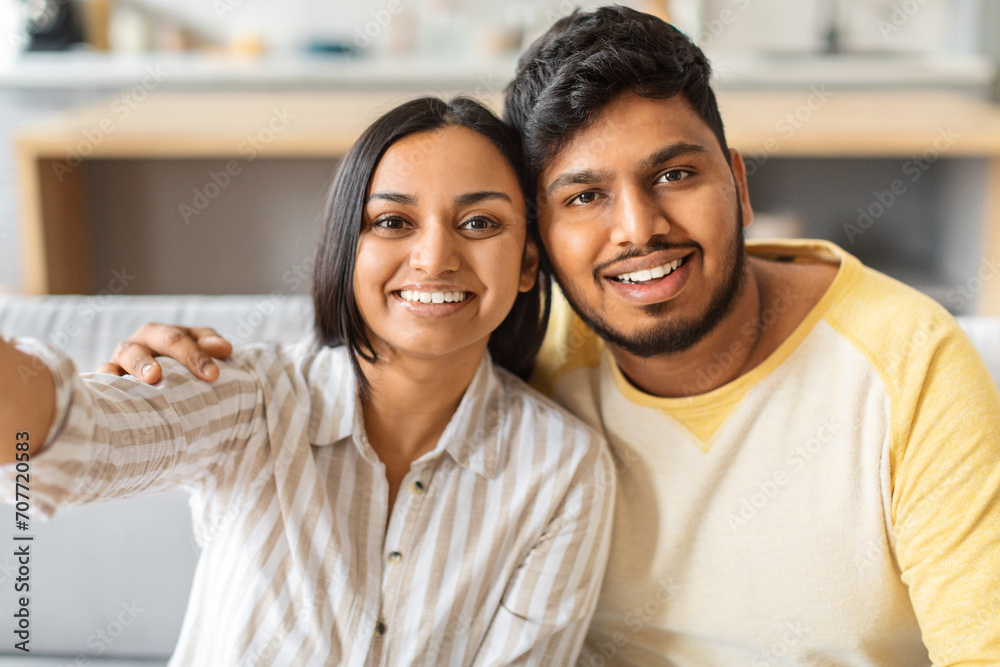 Portrait Of Happy Young Indian Couple Taking Selfie Together At Home