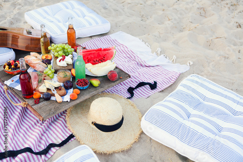 Picnic on the beach at sunset in the style of boho photo