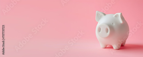Investment concept - whitet pig shaped moneybox, pink solid color background photo
