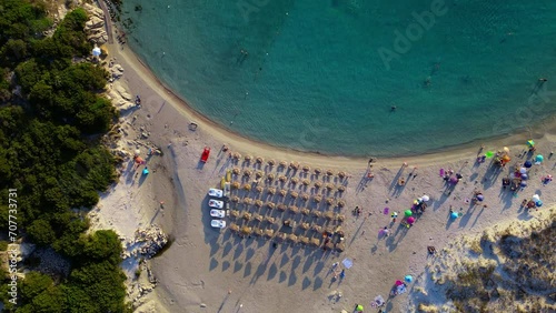 Overhead drone shot revealing beautiful Punta Molentis Beach with tourists sunbathing and swimming, Villasimius, South Sardinia, Italy photo