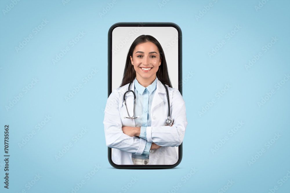 Smiling woman doctor displayed on smartphone screen Smiling woman doctor displayed on smartphone screen