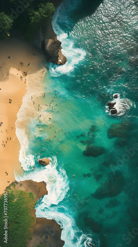 Aerial view of beautiful sandy beach and turquoise ocean with surfers