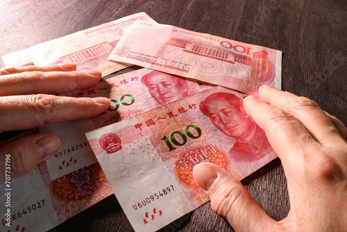 Counting money, Chinese yuan in hands. Concept of Chinese finance and economy. Selective focus. photo
