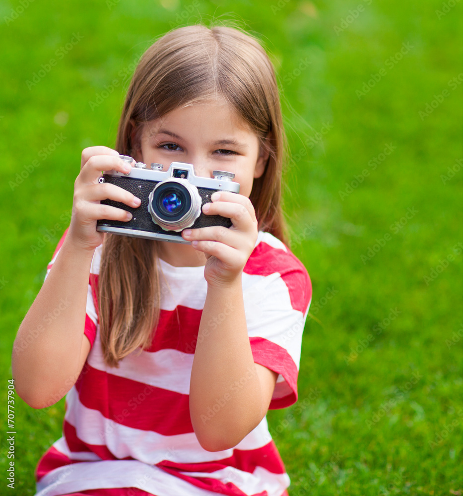 Portrait of a pretty little girl smiling and holding retro camera Portrait of a pretty little girl smiling and holding retro camera