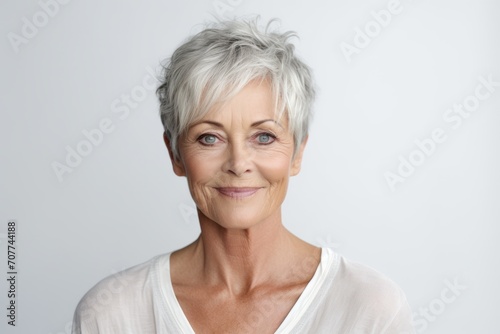 Portrait of senior woman with grey hair looking at camera and smiling