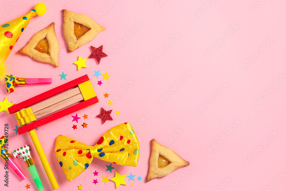 Purim carnival frame with traditional cookies, costume accessories and decor on pastel pink background - obrazy, fototapety, plakaty 