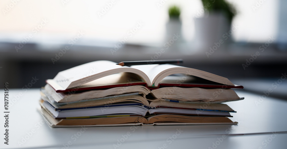 Books lie on the table in office at home. Remote education concept Books lie on the table in office at home. Remote education concept