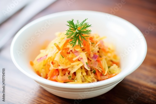 colorful sauerkraut with carrot strips, in white bowl