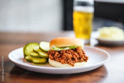 sloppy joe with pickled cucumber slices on the side