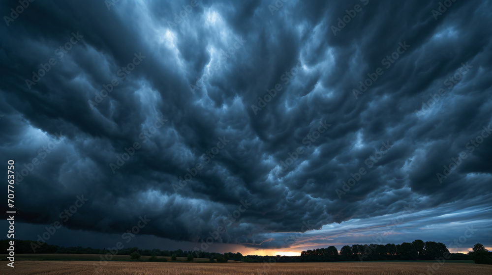 A dark sky filled with mammatus clouds indicating severe weather over a ...