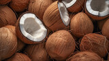 Photorealistic illustration of a pile of husked coconuts whole and broken in half. Colors brown with white accents
