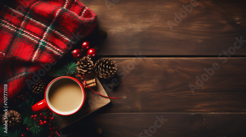 A flat lay of a festive Christmas setting with a red and green plaid scarf pine cones a string of lights a hot cup of mulled wine and wrapped gifts on a cozy wooden background.