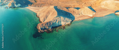 Panoramic view from above of rocky seashore. Seascape with rocky beach and green water. Cabo de Gata-Níjar reserve. Almeria, Spain