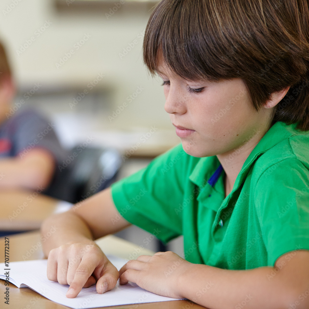 Classroom, notebook and child at desk, reading and education for learning at school exam. Book, studying for test and boy student in classroom with knowledge and thinking with depression on project. Classroom, notebook and child at desk, reading and education for learning at school exam. Book, studying for test and boy student in classroom with knowledge and thinking with depression on project.