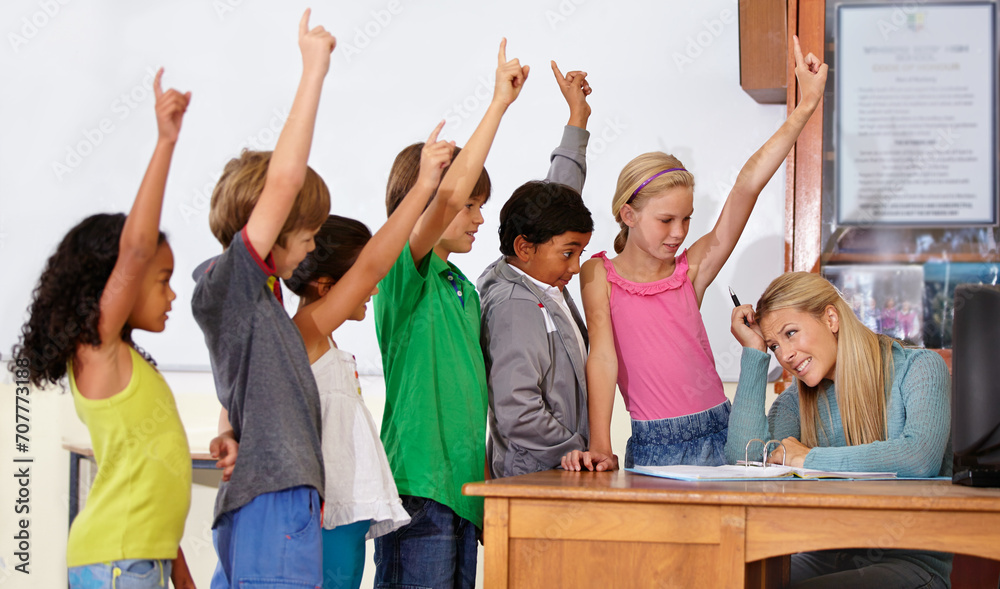 Fototapeta premium Teacher woman, class and children with raised hand for questions, answer or pop quiz with headache. Teaching person, school kids and education for development, scholarship or assessment at academy