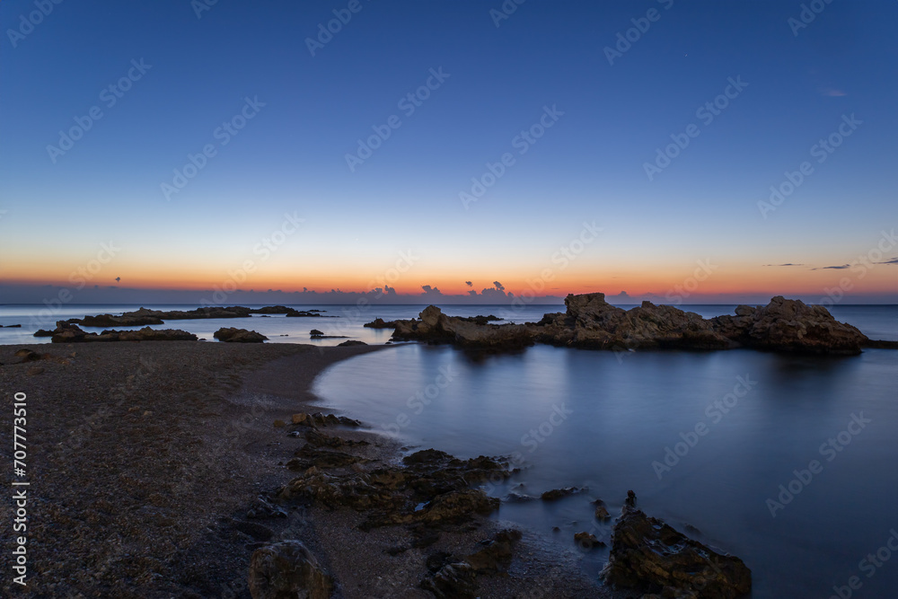 Landscape by the sea in Greece on the island of Rhodes. Sunrise, dramatic clouds. Beautiful background.