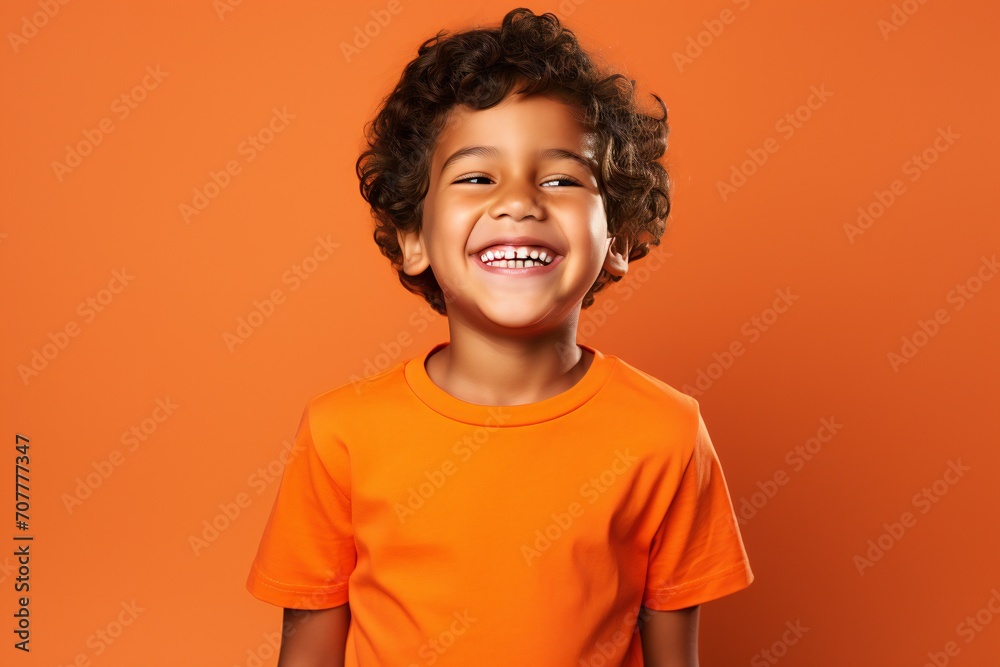 a professional portrait studio photo of a cute mexican boy child model with perfect clean teeth laughing and smiling. isolated on orange background. for ads and web design a professional portrait studio photo of a cute mexican boy child model with perfect clean teeth laughing and smiling. isolated on orange background. for ads and web design