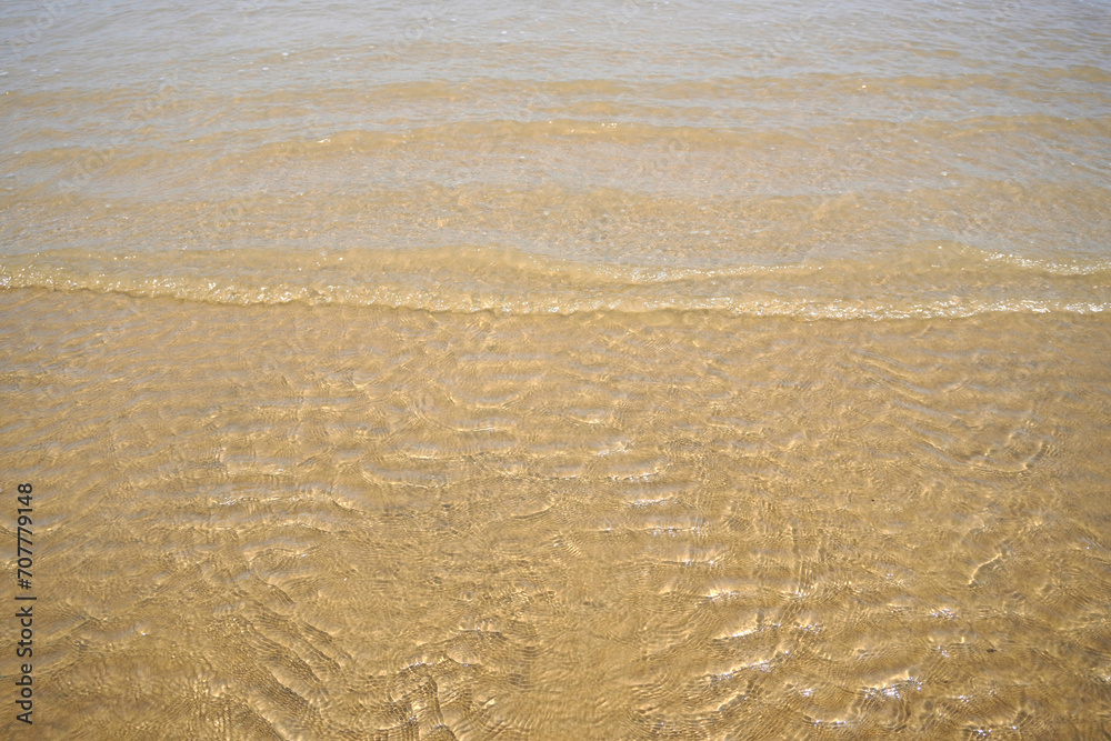 Beach waves with clear water. small wave ripples Beach waves with clear water. small wave ripples