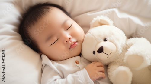 Newborn Asian baby boy sleeping with a teddy bear. Generative AI.