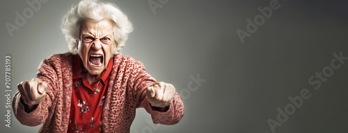 Elderly woman grandmother screams in angry anger, aggressively disappointed, white background isolate. photo