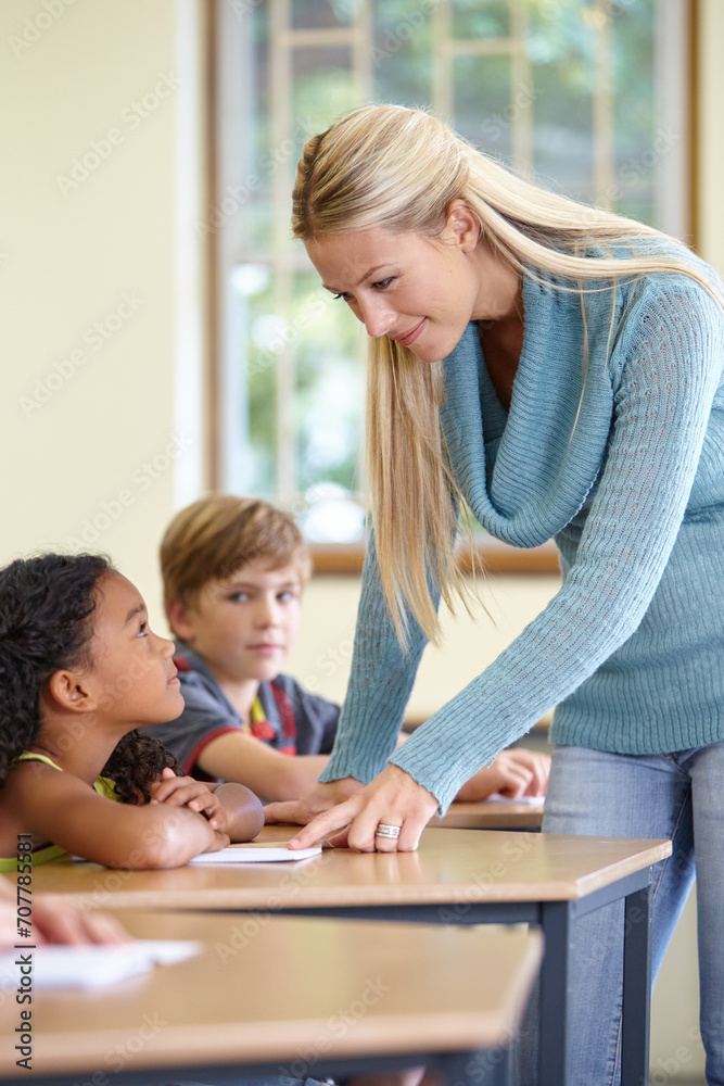 Teacher, students and child in classroom for education, learning and writing or language development with support. Happy woman and girl for teaching, helping with knowledge and questions at school Teacher, students and child in classroom for education, learning and writing or language development with support. Happy woman and girl for teaching, helping with knowledge and questions at school