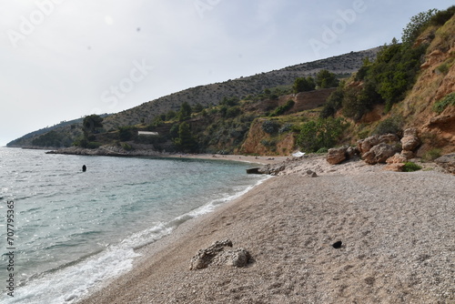 Pebble Beach with Hillside and Clear Waters