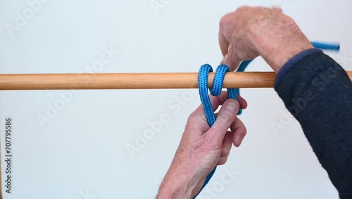 Tying a rope to a spar using a Round Turn and Two Half Hitches photo