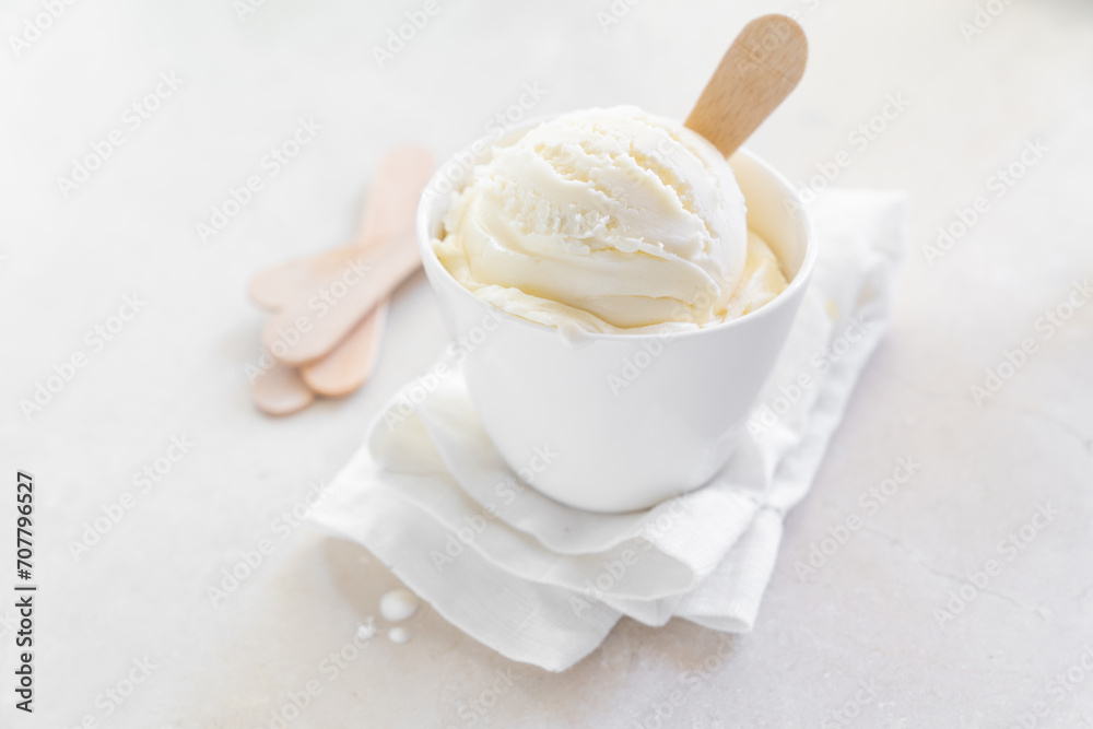 Vanilla ice cream in white cup, marble background Vanilla ice cream in white cup, marble background