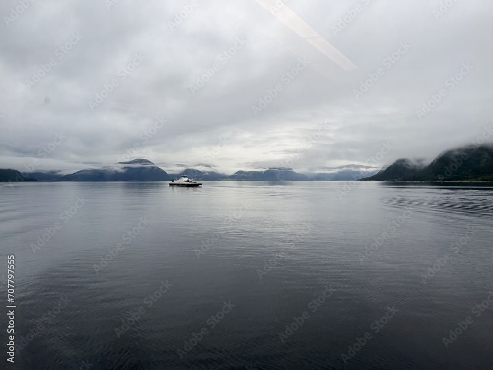 A scene of a ferry on a rainy day crossing the Sogn Fjord, Norway