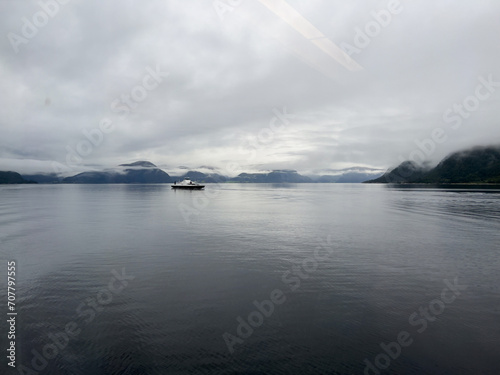 A scene of a ferry on a rainy day crossing the Sogn Fjord, Norway