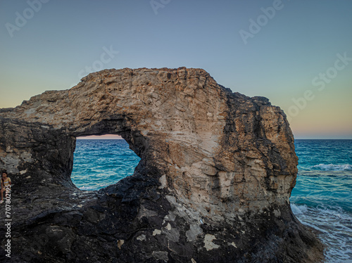 Giant rock with a hole in the sea © Amr Kotb