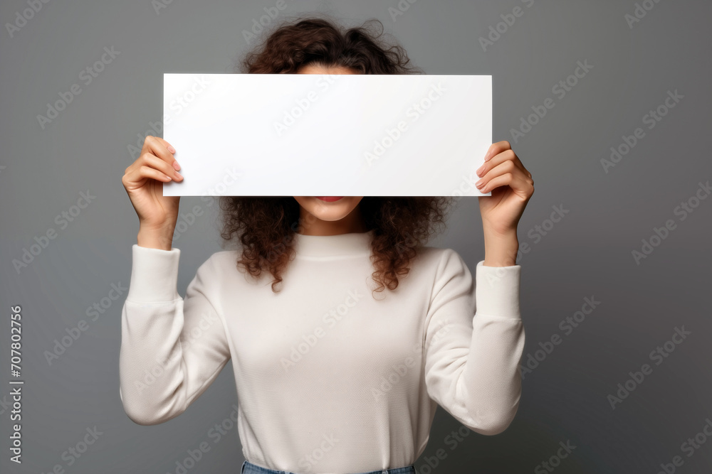 young african american woman covering face with blank sheet of paper young african american woman covering face with blank sheet of paper