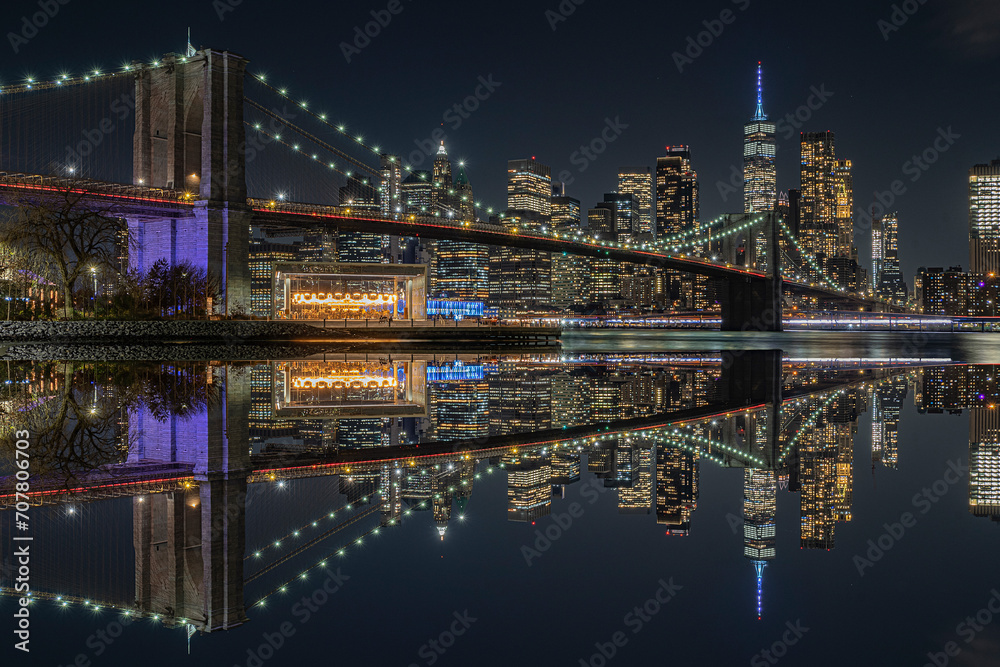 view of the brooklin bridge at night with reflections. manhattam skyline, brooklyn bridge. New York City
