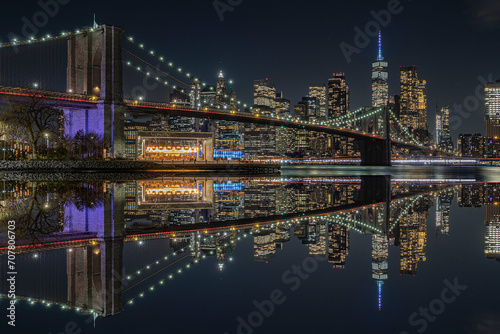 view of the brooklin bridge at night with reflections. manhattam skyline  brooklyn bridge. New York City