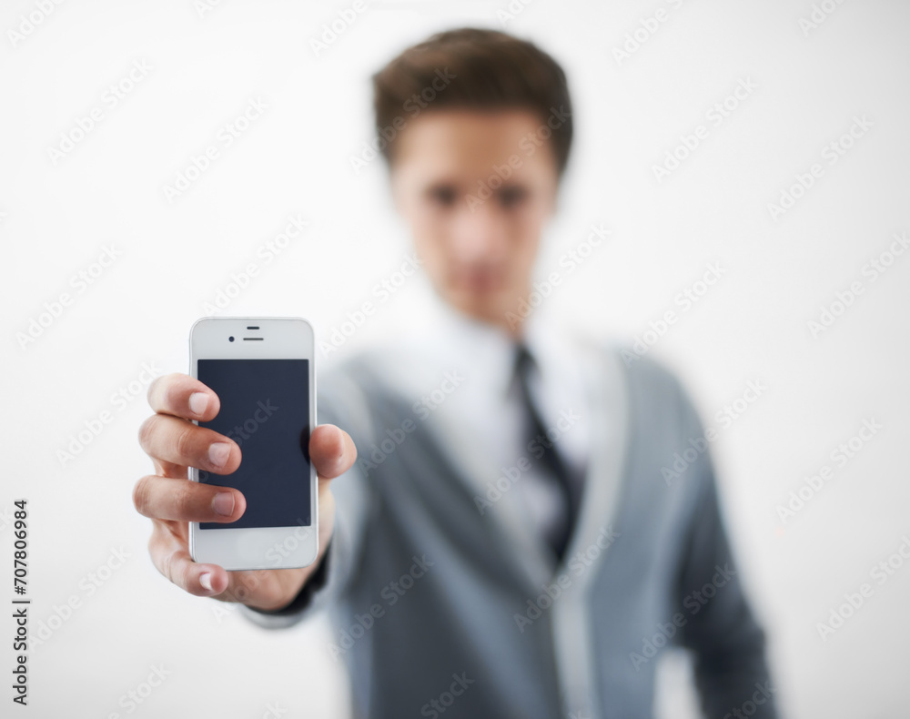 Man, hands and phone screen for advertising or marketing against a gray studio background. Closeup of male person or employee showing mobile smartphone or tech display for online app on mockup space