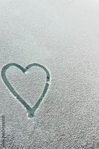 A heart drawn on a snow-covered car window. Copy space. Winter day. Transport  Valentine s Day