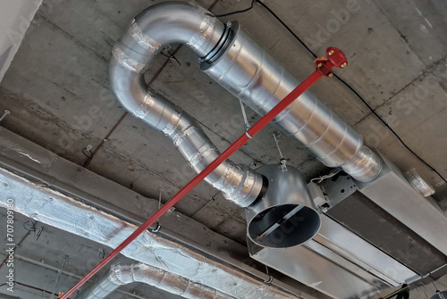 dampers cooling the building with a fan blowing air into the building. extraction of steam from the kitchen from metal sheets. protected escape route from the building, red, plumber, plumbline photo