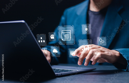 Businessman use laptop with virtual document management system for online document database and automated processes in file management, Search and manage document database files online.