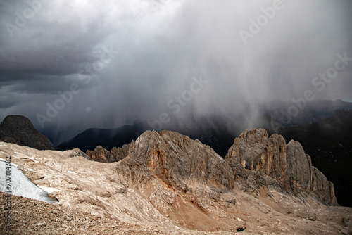 The view of Sassolungo and the Sella Group from Serauta in stormy weather in the Dolomites, Italy.