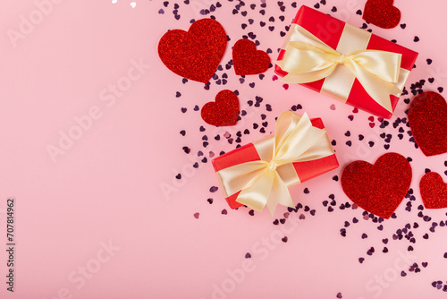 Valentine's Day concept. Valentine's Day background. Gifts, candles, confetti, envelope - postcard on a pink background. Flatley, top view, copy space.Valentine's day celebration